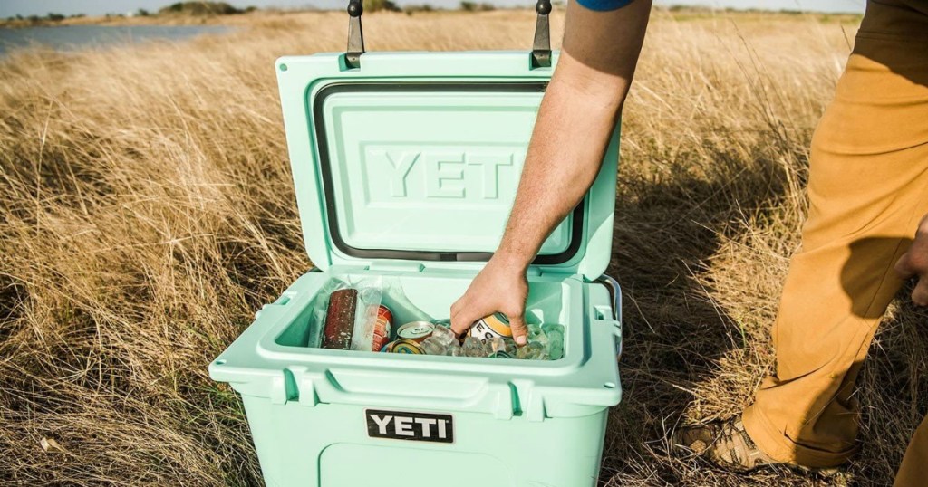 person reaching into a cooler