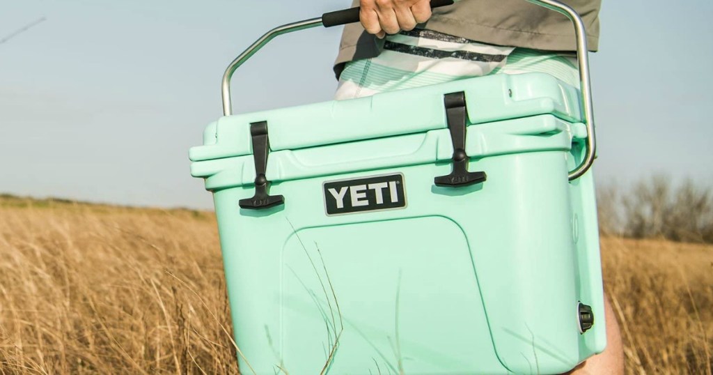 person carrying a YETI cooler