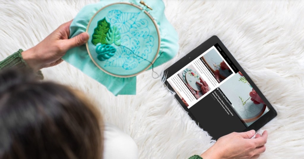 woman sewing with tutorial on tablet