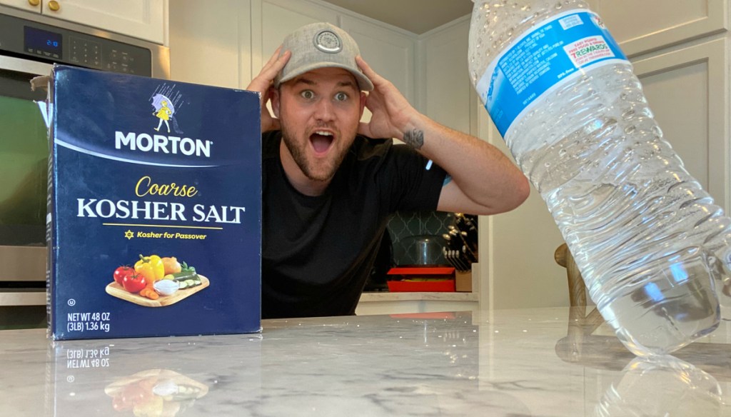 man looking surprised at water bottle