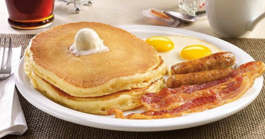 plate with pancakes bacon and eggs