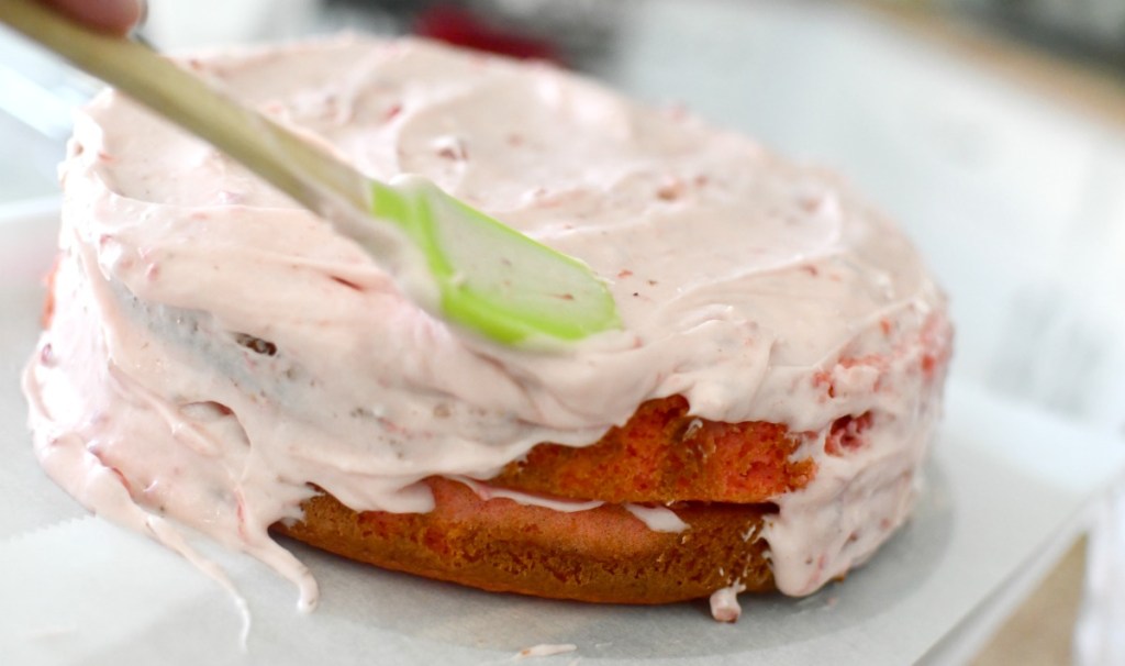 frosting a strawberry cake