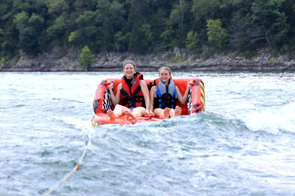 woman and girl tubing in lake