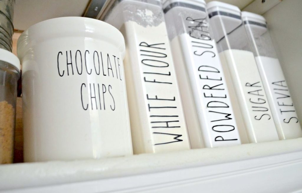 row of baking goods in plastic containers with modern labels