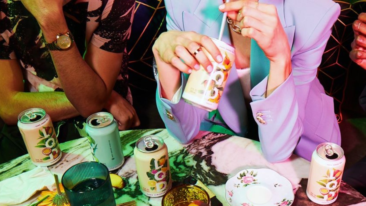 woman drinking with a straw from a can