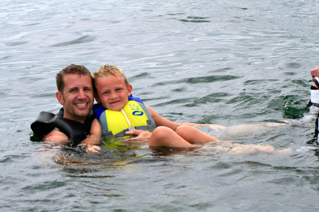 man and boy in lake