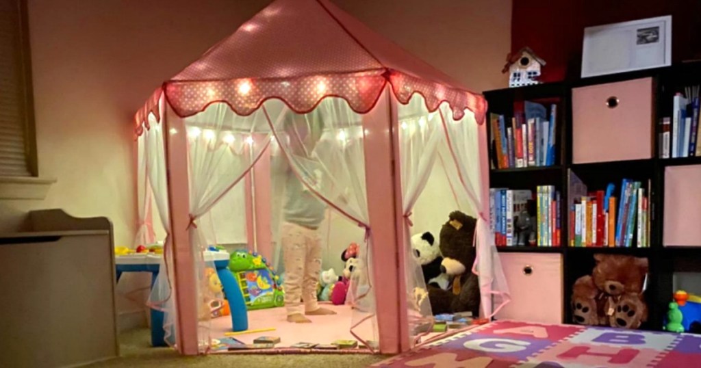 pink kids play tent with lights in bedroom