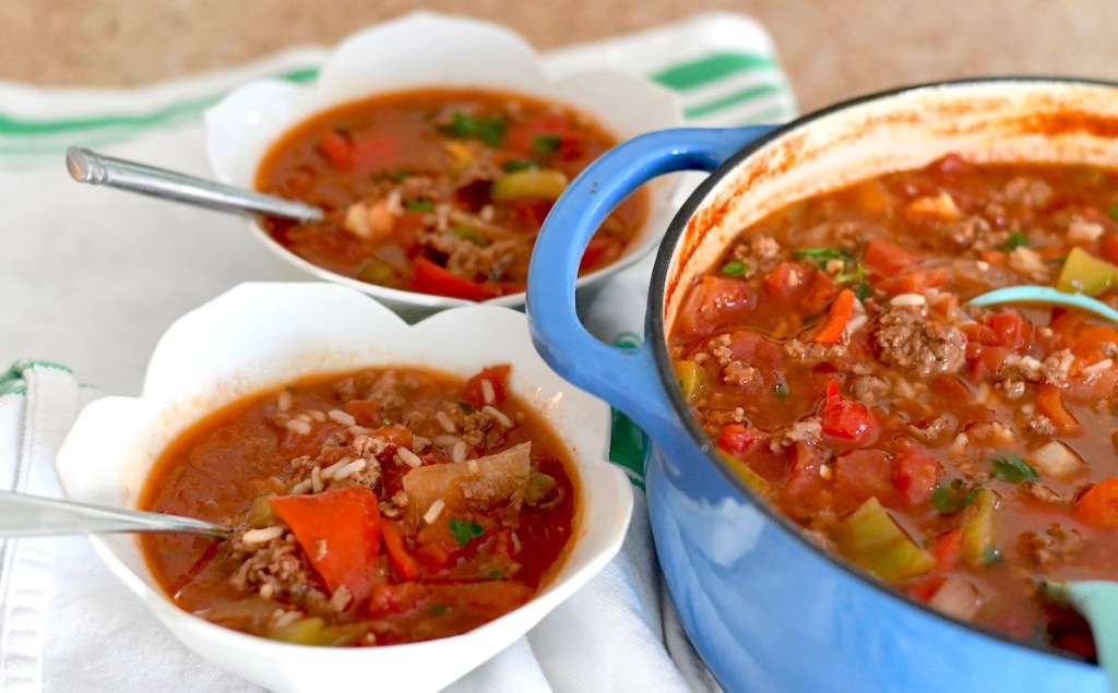 colorful soup with blue stock pot and white bowls