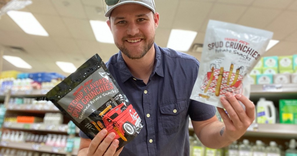 man holding 2 bags of Trader Joe's spud crunchies