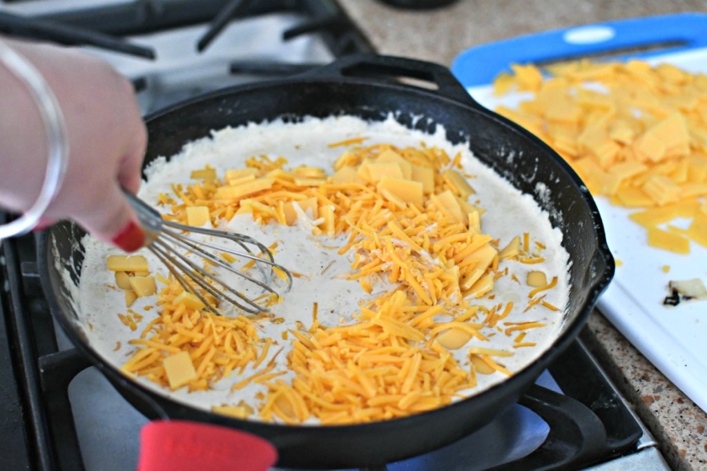 stirring cheese into cheese sauce