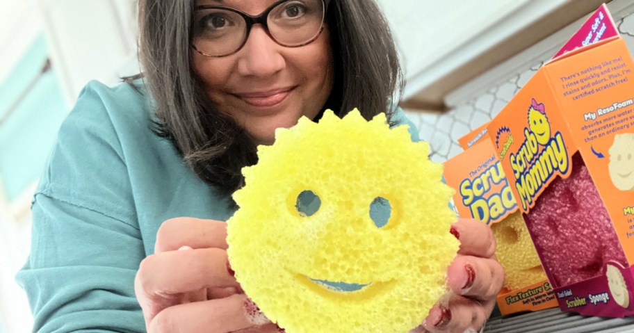 woman holding a scrub daddy sponge