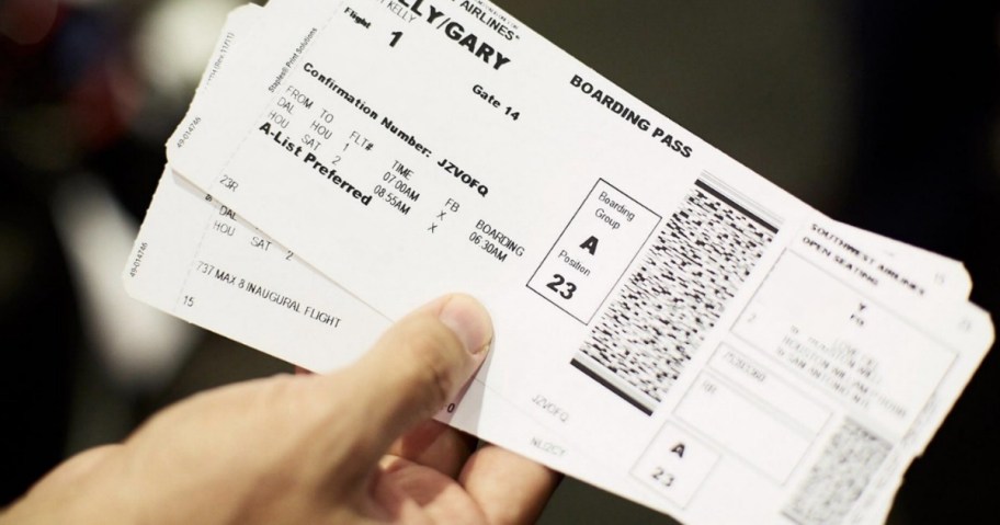 man holding airline tickets