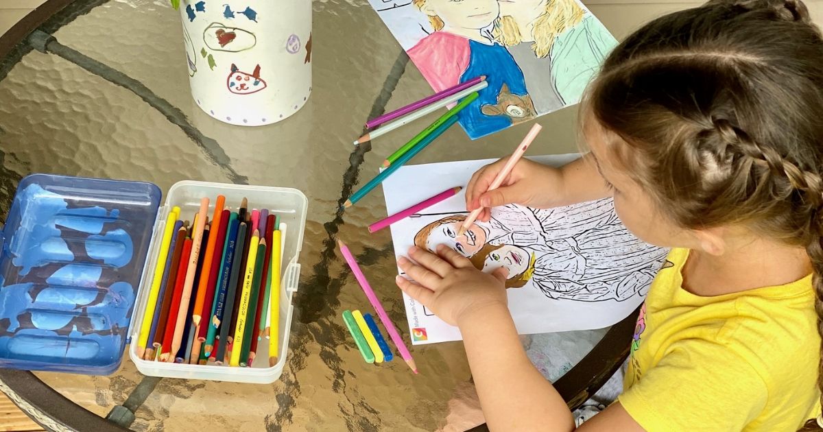 A little girl coloring pictures made from the Colorscape app