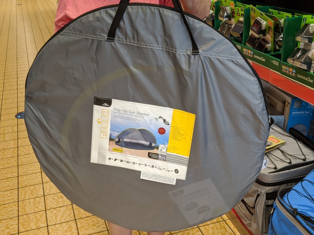 woman holding sun shelter in store