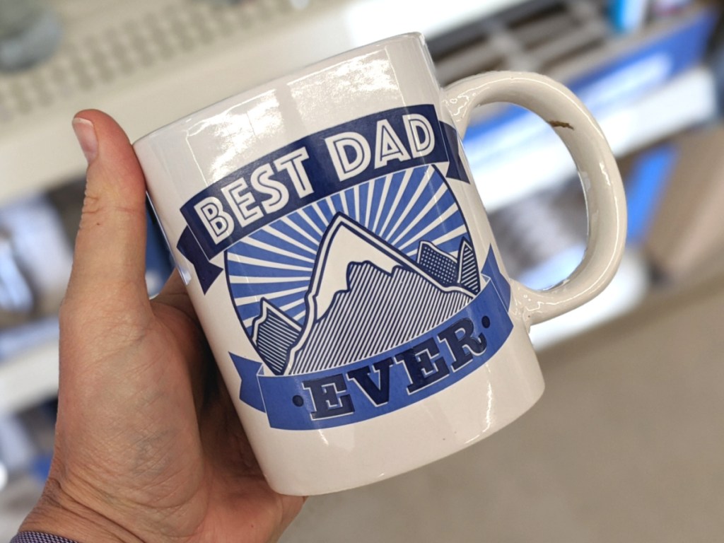 hand holding best dad ever mug at dollar tree