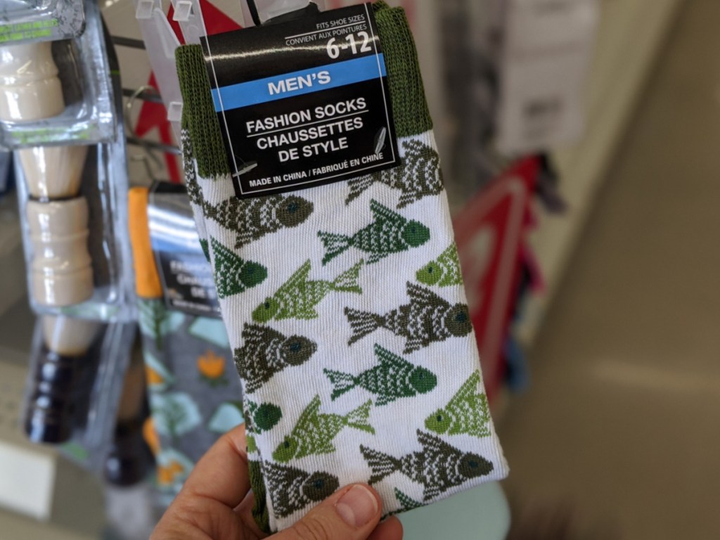 handing holding men's fishing socks in store at dollar tree