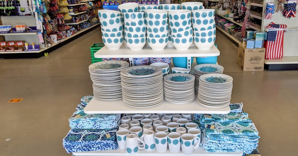 store display with blue and turquoise mediterranean themed dinnerware with plates, mugs, and bowls