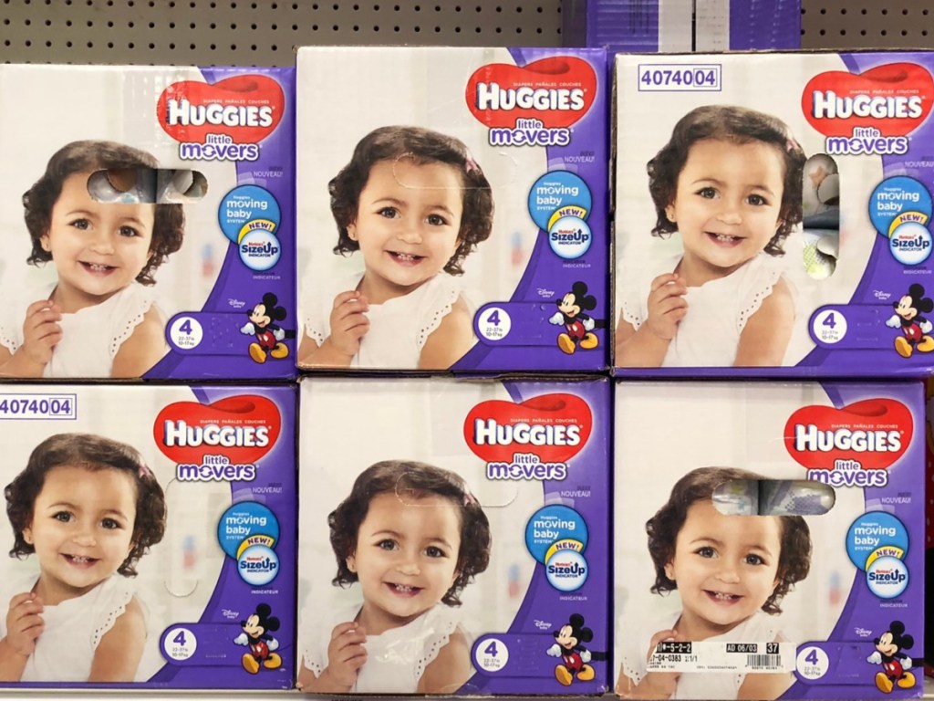 multiple large boxes of diapers on a store shelf