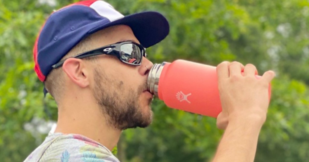 Man sipping from brightly colored Hydro Flask