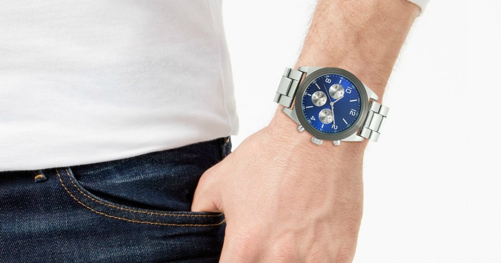 man wearing a watch with hand tucked into pocket