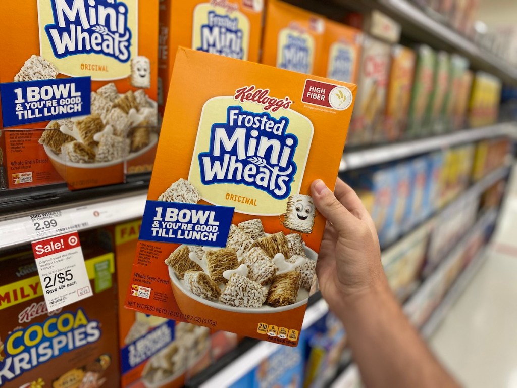 hand holding box of Kellogg's Mini Wheats