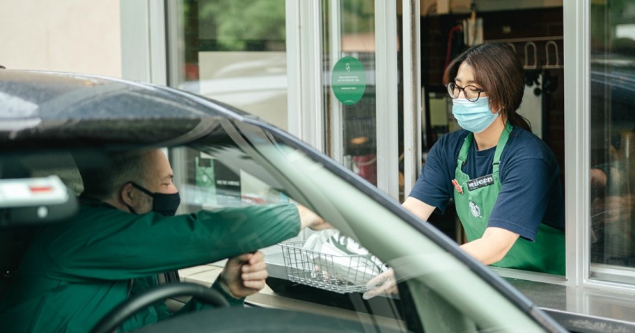 Man in car going through Starbucks Drive-Thru