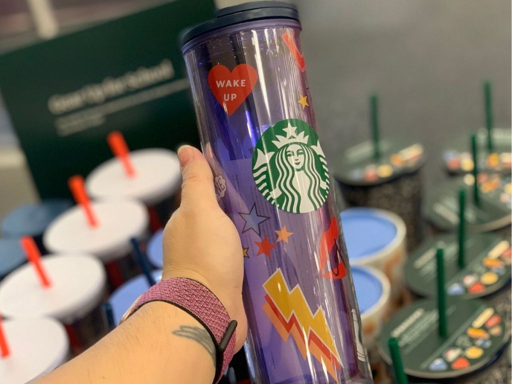 Woman's hand holding a plastic tumbler