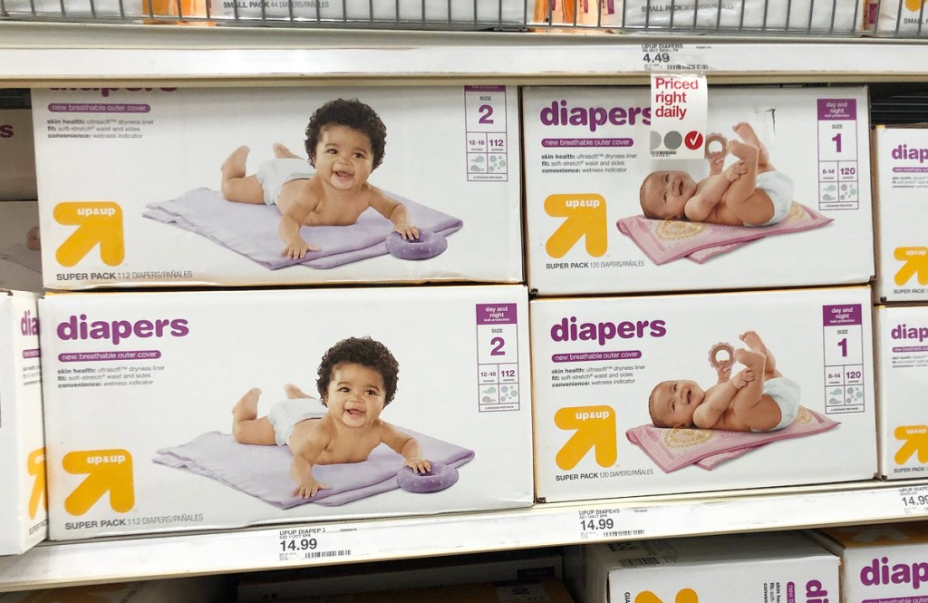 store display shelfs full of white and yellow boxes of up & up brand diapers