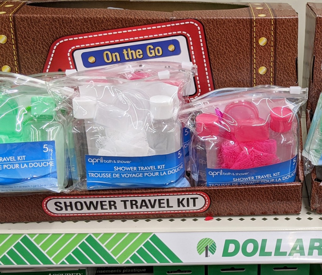 dollar tree store shelf with travel shower kits in green, white, and pink colors