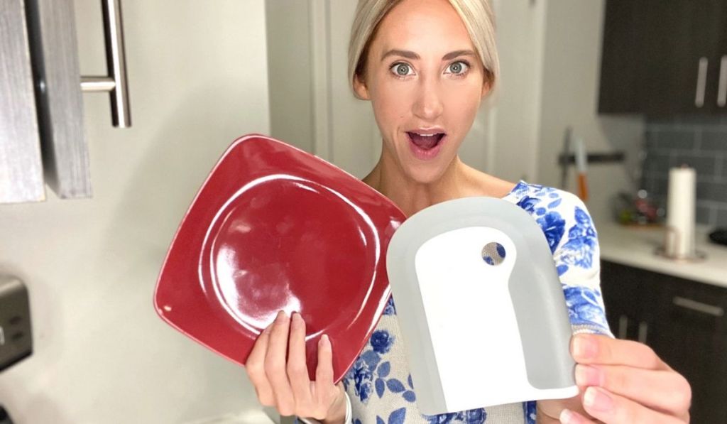 woman holding clean plate and dish squeegee