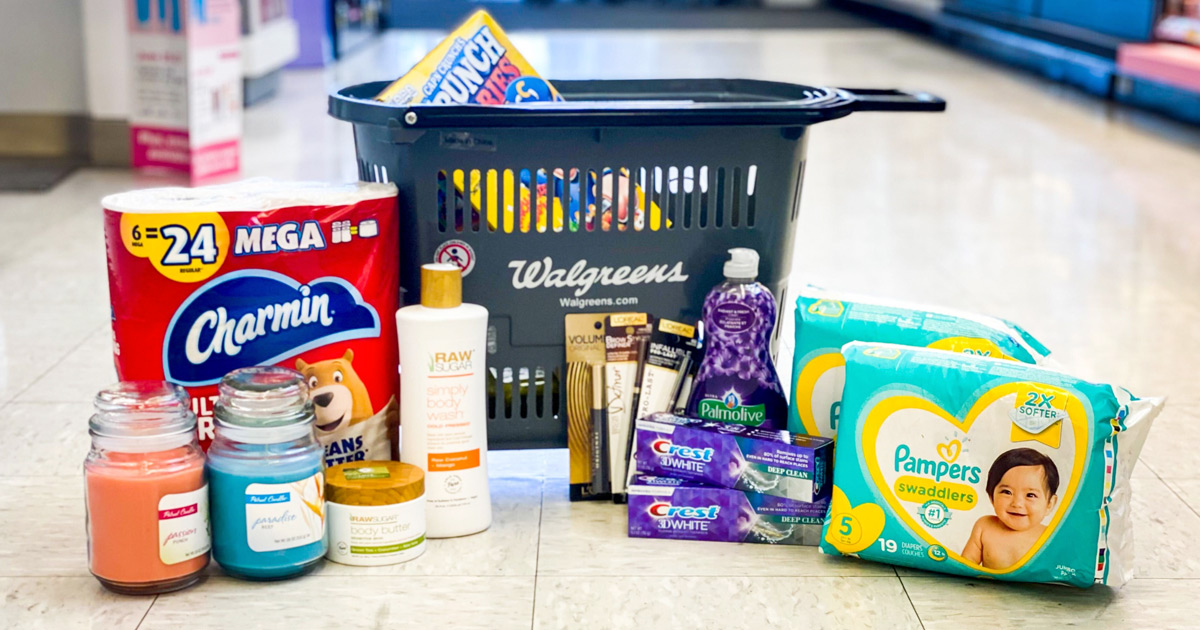 candles, charmin toilet paper, crest toothpaste, dish soap, and pampers diapers on floor in front of walgreens shopping basket