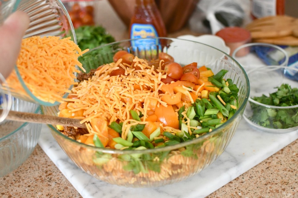 adding cheese to taco salad