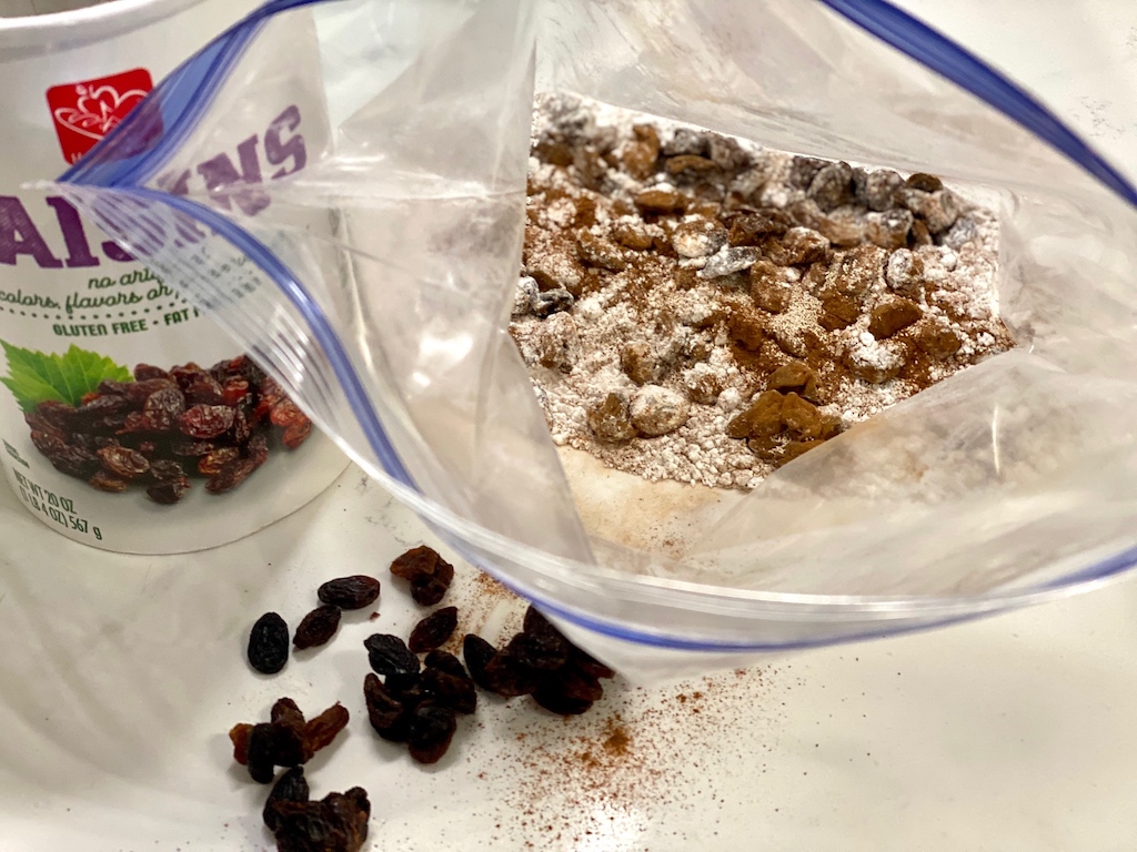 cinnamon, raisins and flour in ziploc bag