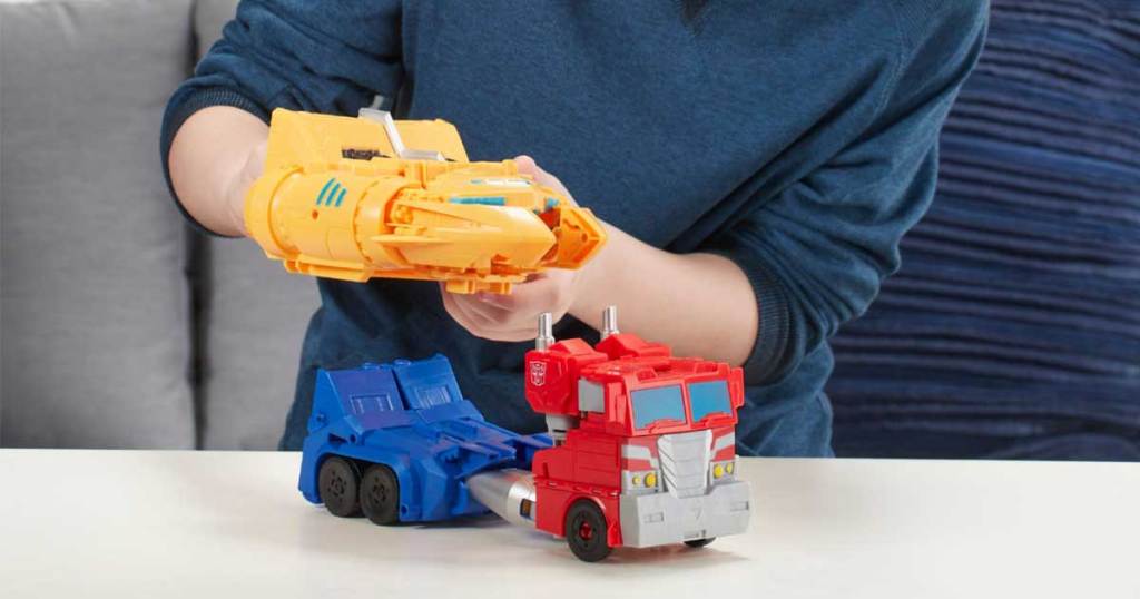 boy playing with optimus prime transformer