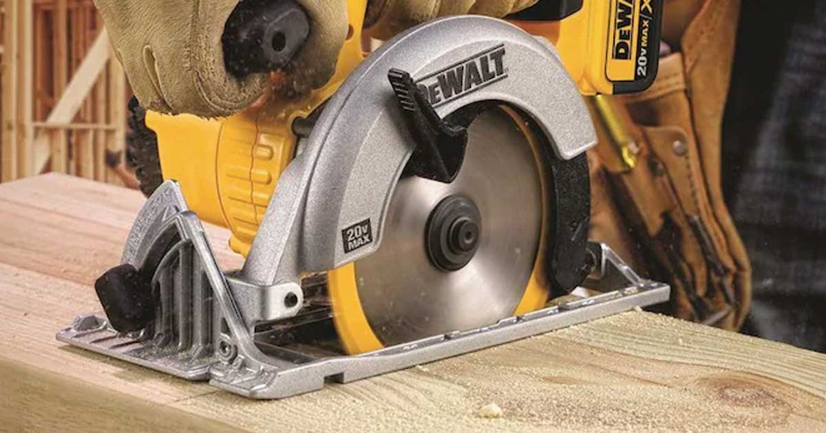 man using DeWalt saw on a cutting table