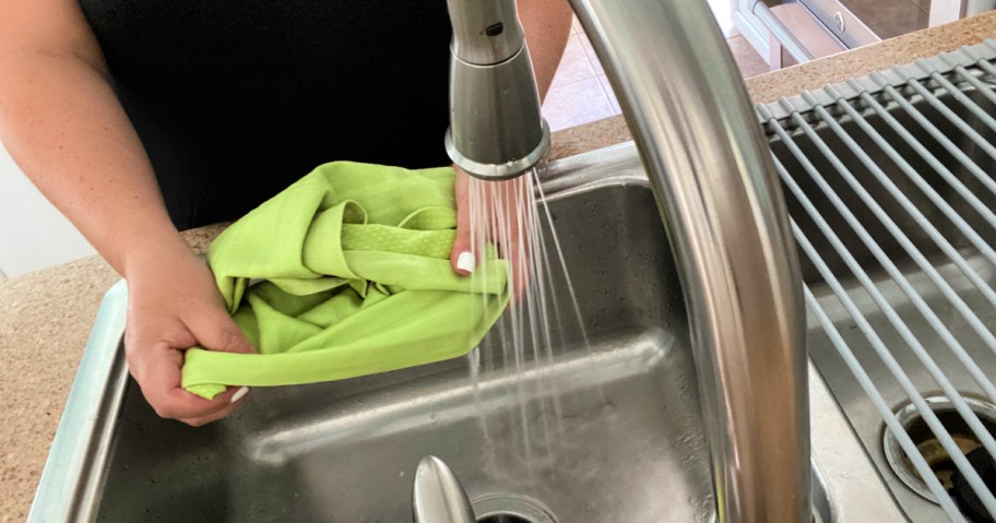 hands washing blue frogg togg in sink