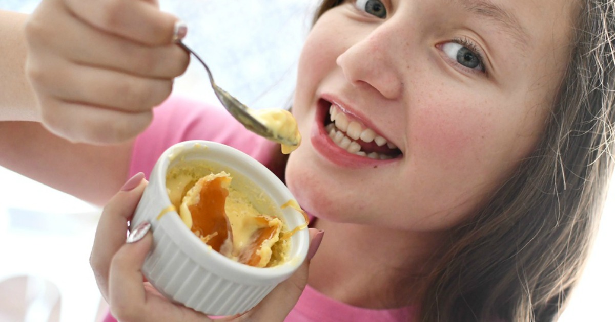 girl eating creme brulee on spoon 