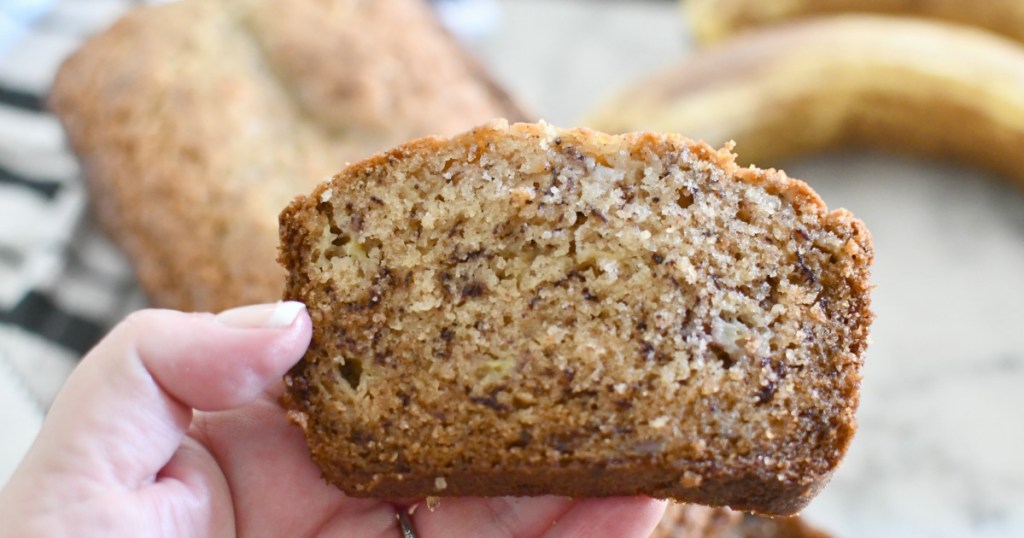 holding a slice of banana bread