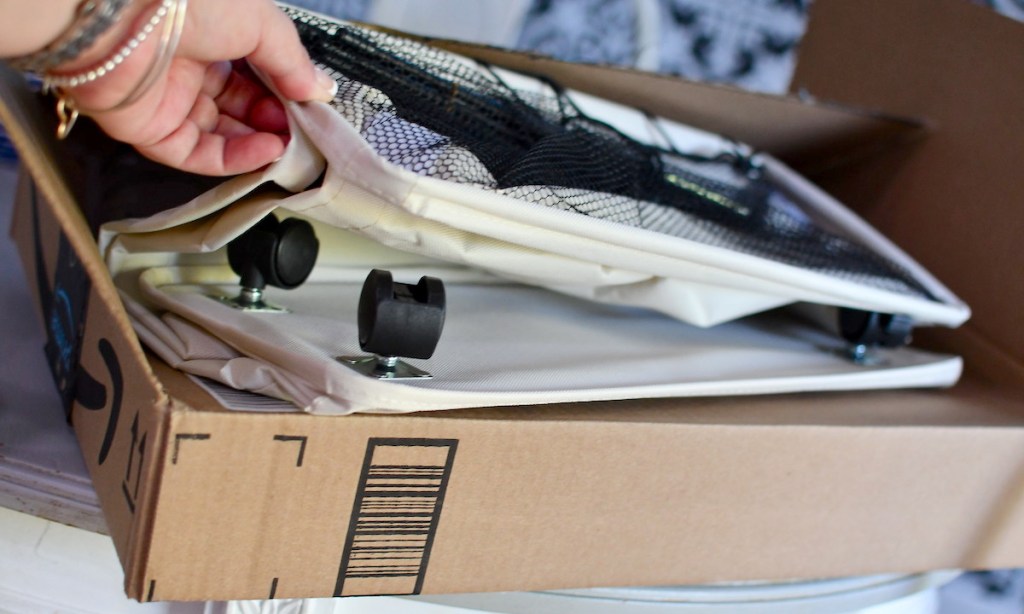 hand holding a basket on wheels off amazon box