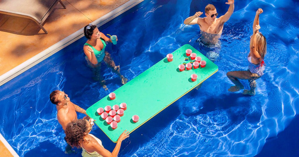 people playing in a pool with a Floatation IQ: Hydrapong Floating Table