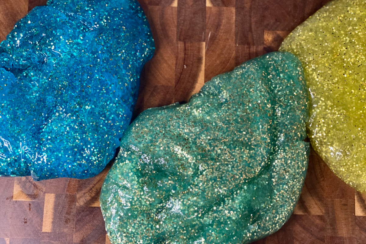 Three different colors of slime on counter