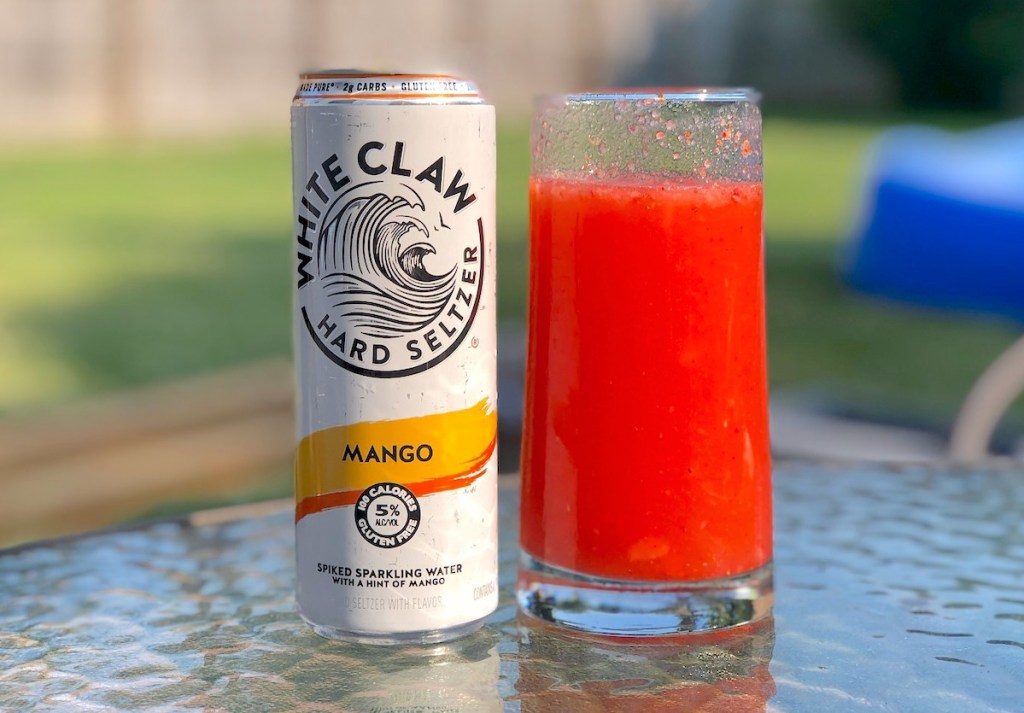 white claw mango slushie sitting on outdoor table