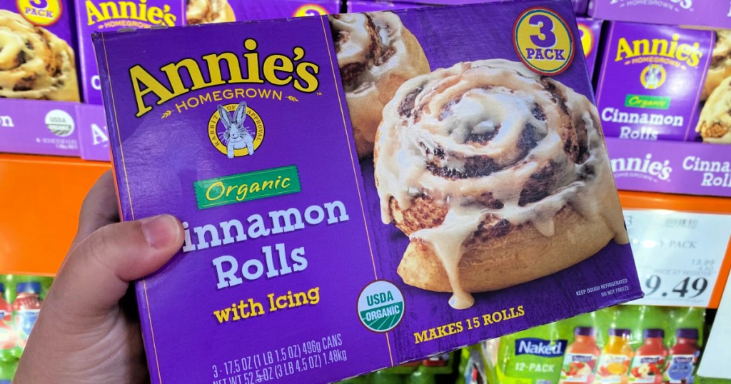 person holding a Annie's Organic Cinnamon Rolls Box