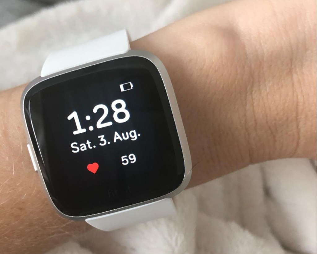 white fitbit on wrist 