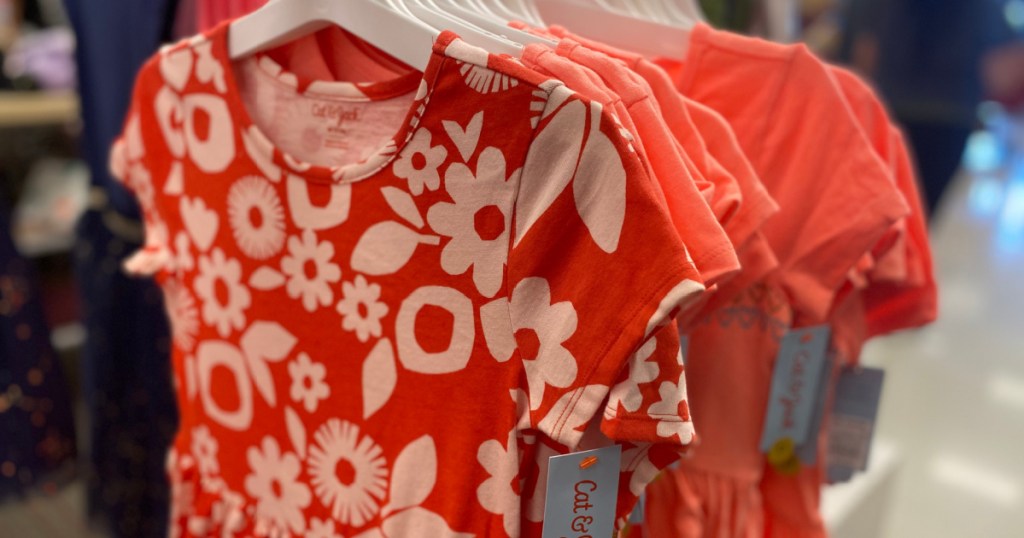 girls coral dresses hanging in store