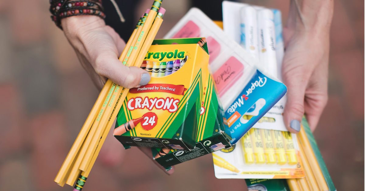 woman holding school supplies