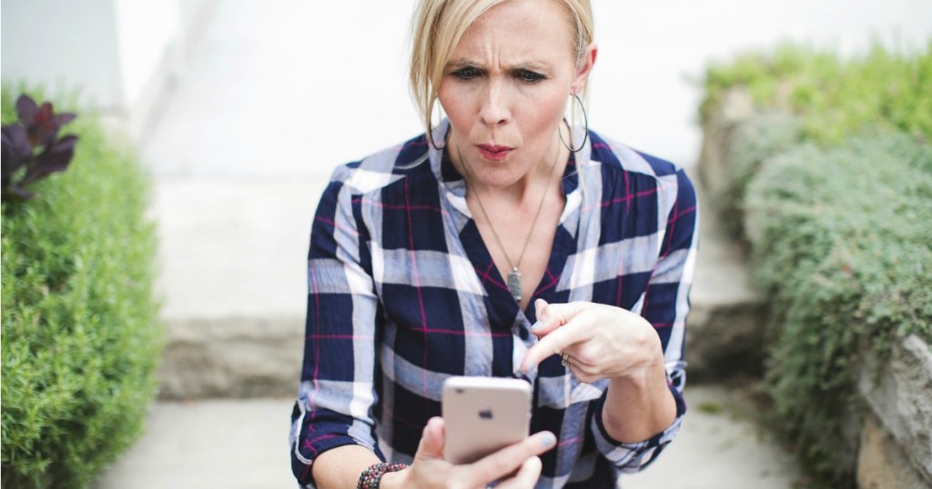 woman looking at iphone