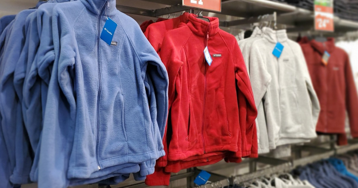 various colored fleece jackets hanging in store