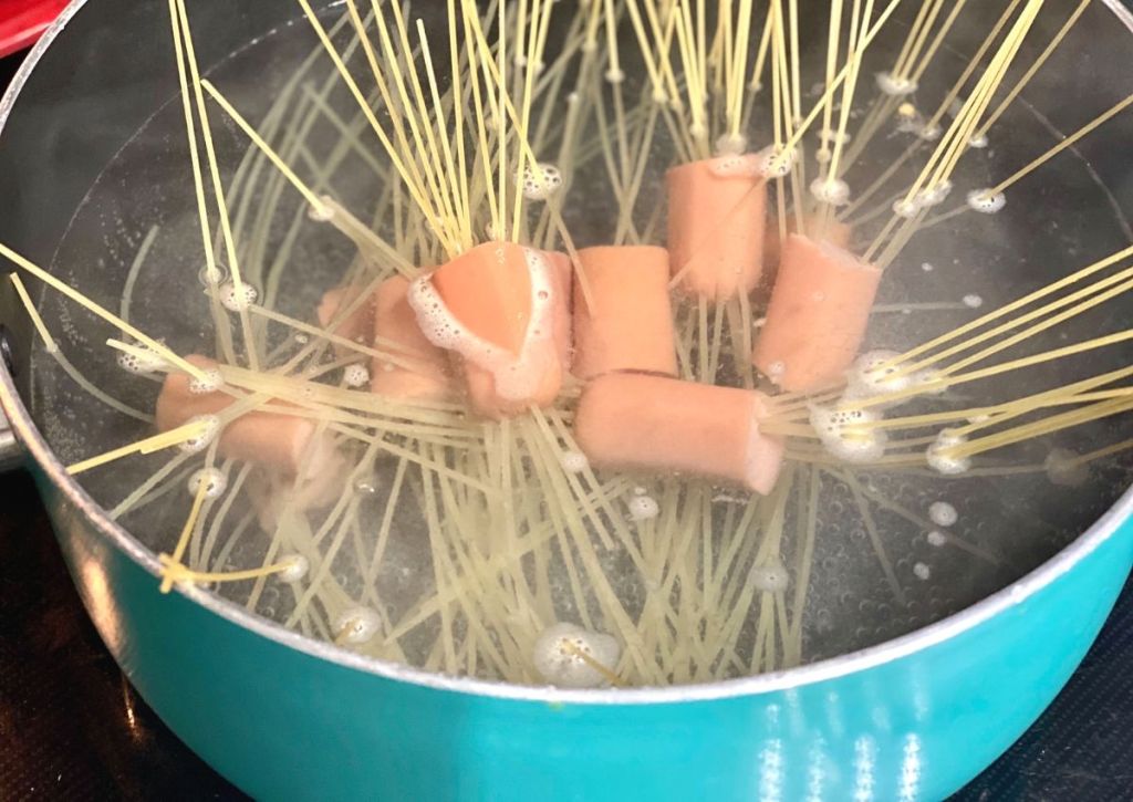 Hot dog noodles boiling in water