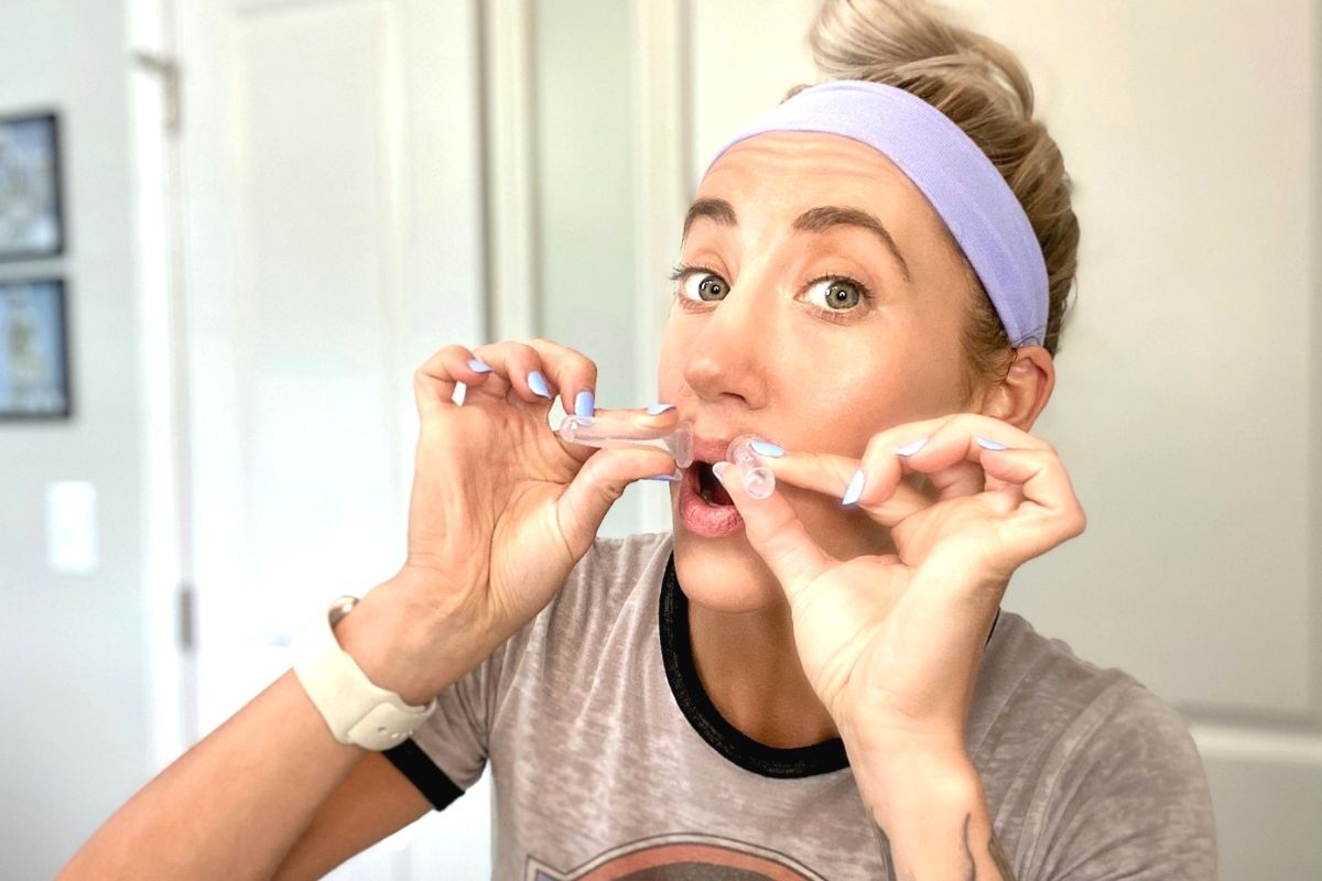 A woman using suction cups to plump lips